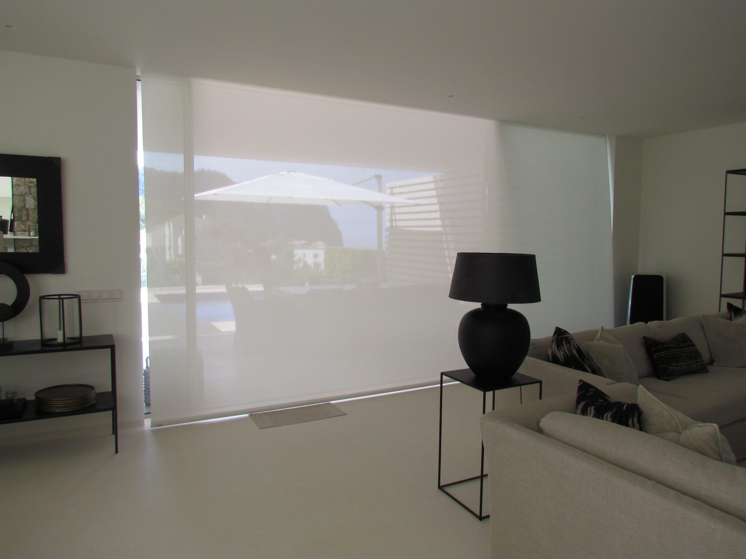 Translucent roller blind with the parasol and terrace visible through it