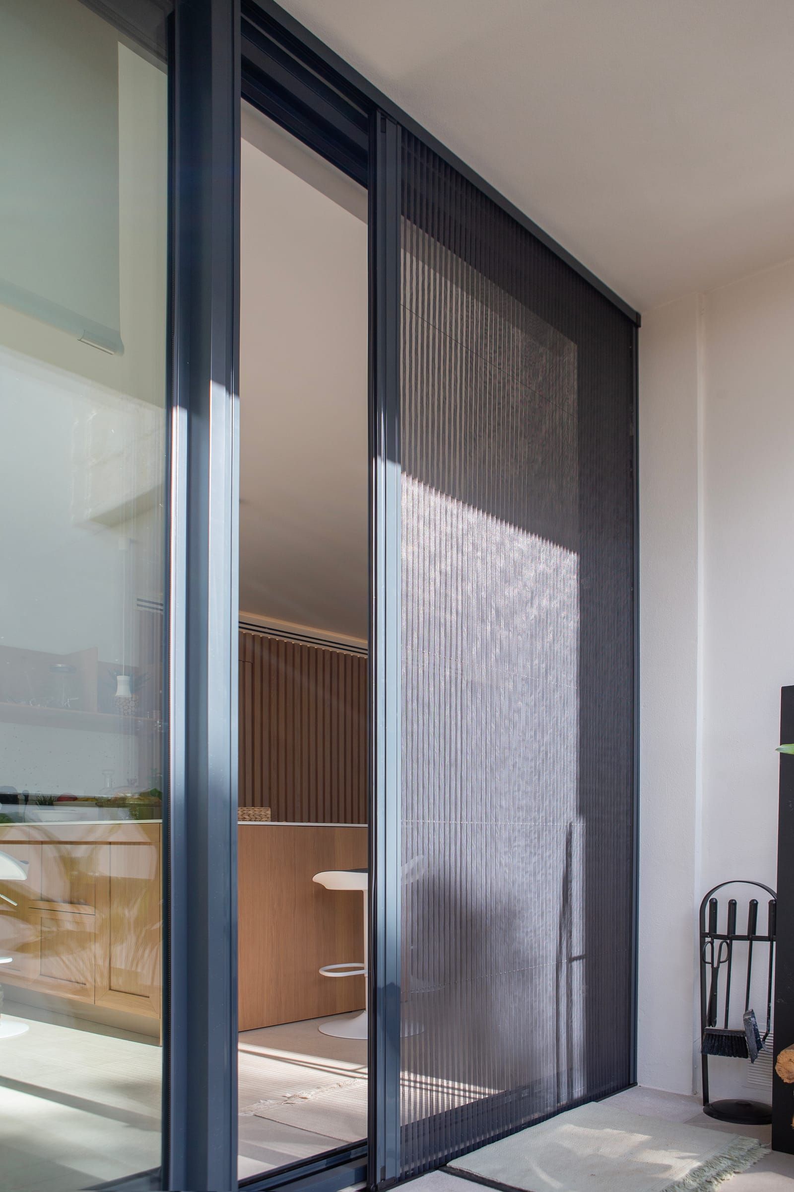 Closed pleated insect screen on a floor-to-ceiling sliding window