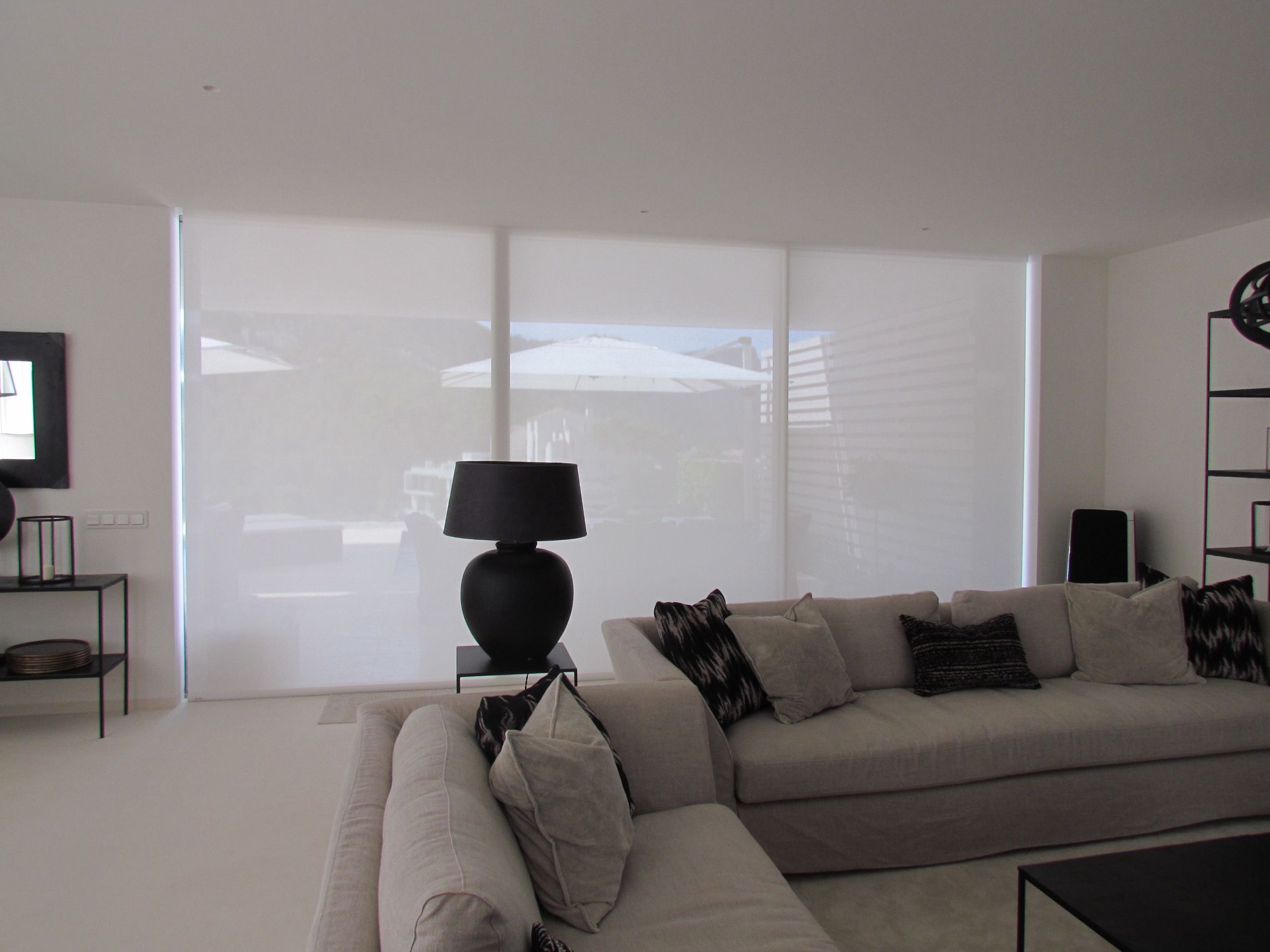 Roller blind lowered over a glazed wall in a Puerto de Andratx home, Mallorca