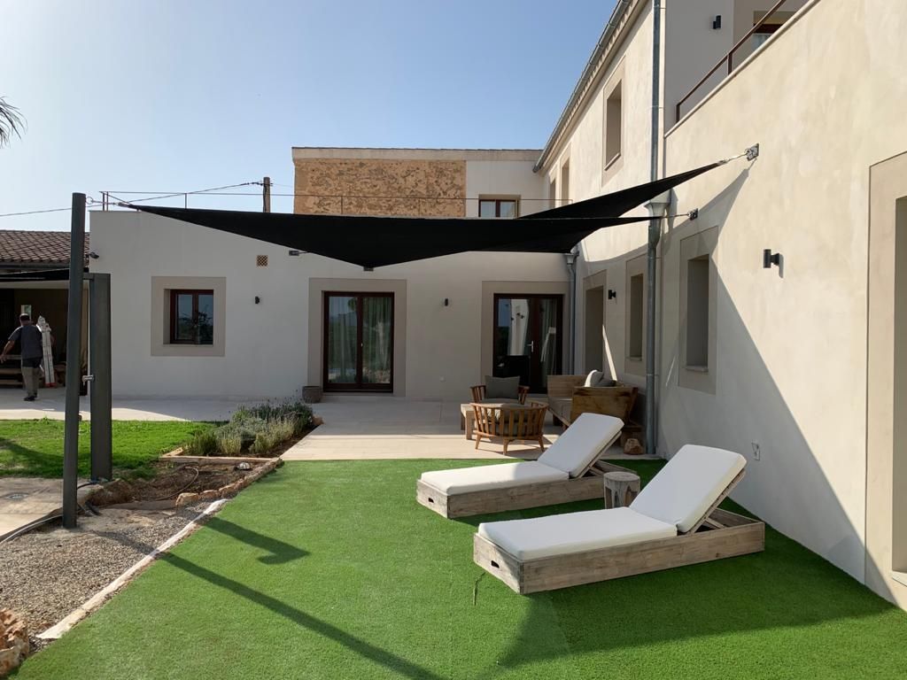 Overlapping triangular shade sails forming a rectangle in Santa Maria de Camí, Mallorca