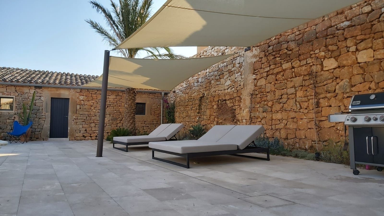 Shade sail designed around a barbecue extractor hood in Santanyí, Mallorca