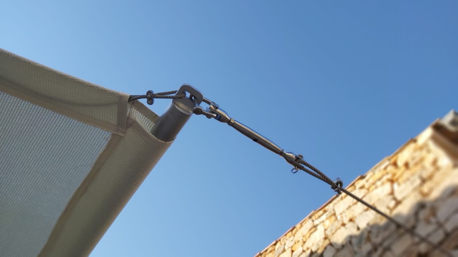 Detail of a shade sail fabric fitted alongside a barbecue area in Santanyí, Mallorca